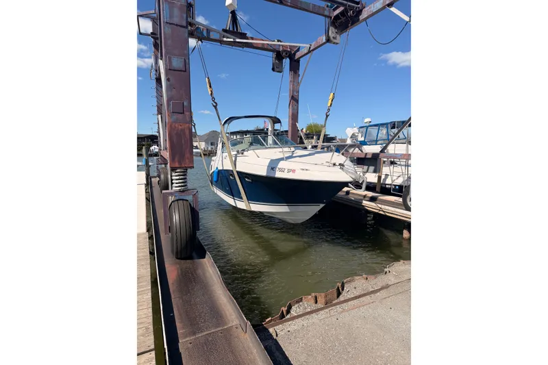 The Image of 2004 Four Winns 268 Vista boat being lifted at a marina. - 0