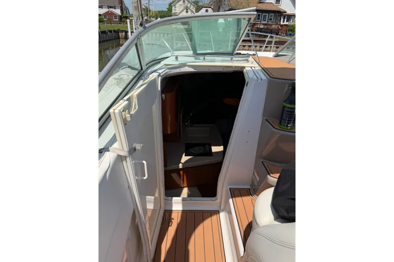 Slide: The Image of 2004 Four Winns 268 Vista boat cabin entrance with open door and teak flooring. - 10