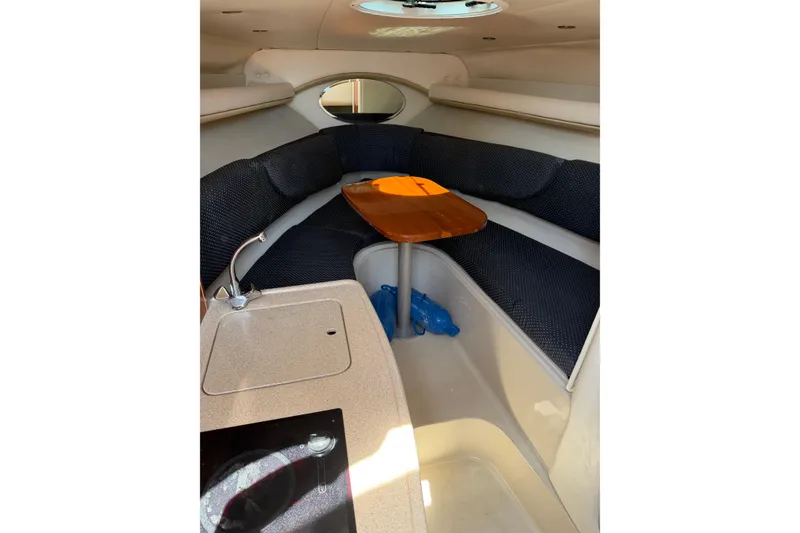 Slide: The Image of Interior of 2004 Four Winns 268 Vista boat with seating and kitchenette. - 13