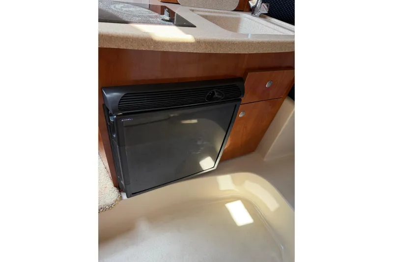 Slide: The Image of 2004 Four Winns 268 Vista boat interior with compact fridge and sink. - 15