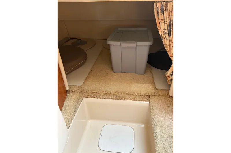 Slide: The Image of Interior cabin of 2004 Four Winns 268 Vista boat with storage bin and carpeted floor. - 17