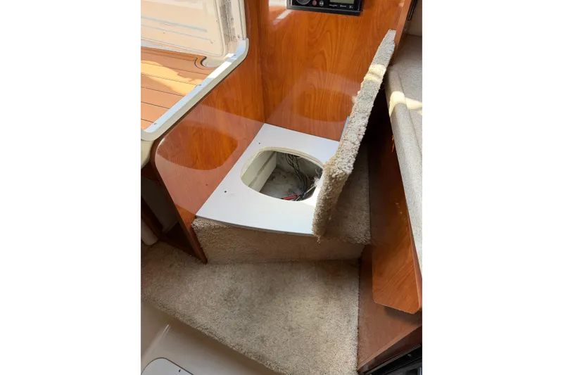 Slide: The Image of 2004 Four Winns 268 Vista interior with open carpeted hatch revealing wiring. - 18