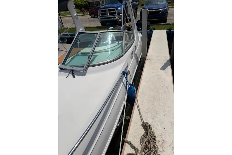 Slide: The Image of 2004 Four Winns 268 Vista boat docked with open windshield and blue fender. - 4
