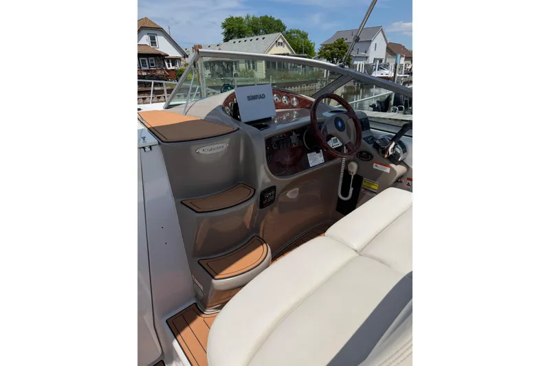 Slide: The Image of 2004 Four Winns 268 Vista boat interior with steering wheel and navigation equipment. - 7