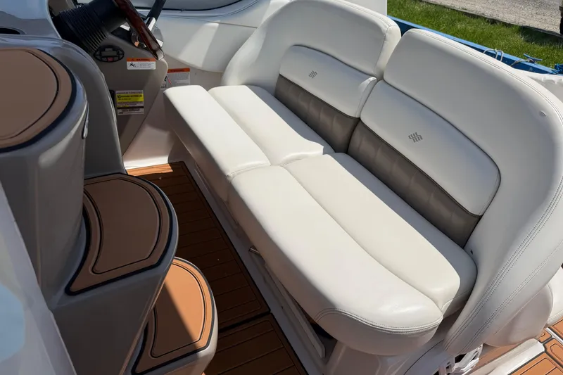 Slide: The Image of 2004 Four Winns 268 Vista boat interior with white leather seating and wooden flooring. - 8