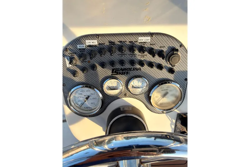 Slide: The Image of Dashboard of a 2013 Carolina Skiff 198 DLV boat with gauges and switches. - 19
