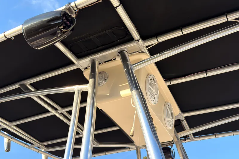 Slide: The Image of T-top structure of a 2013 Carolina Skiff 198 DLV boat with speakers and spotlight. - 22