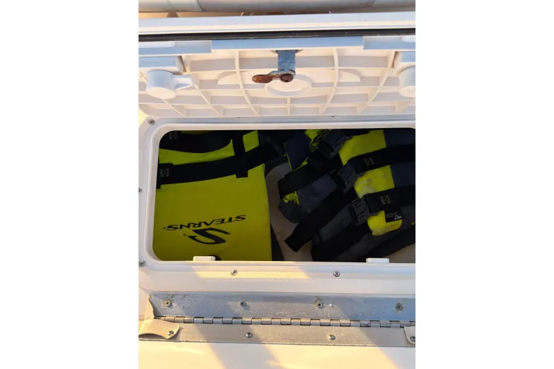 Slide: The Image of Storage compartment on a 2013 Carolina Skiff 198 DLV with life jackets inside. - 29