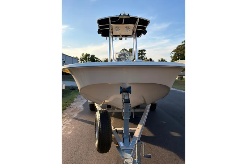 Slide: The Image of 2013 Carolina Skiff 198 DLV boat on trailer, parked on a sunny street. - 4