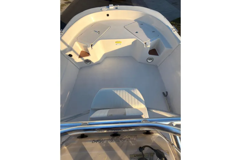 Slide: The Image of 2013 Carolina Skiff 198 DLV boat interior with seating and storage compartments. - 5