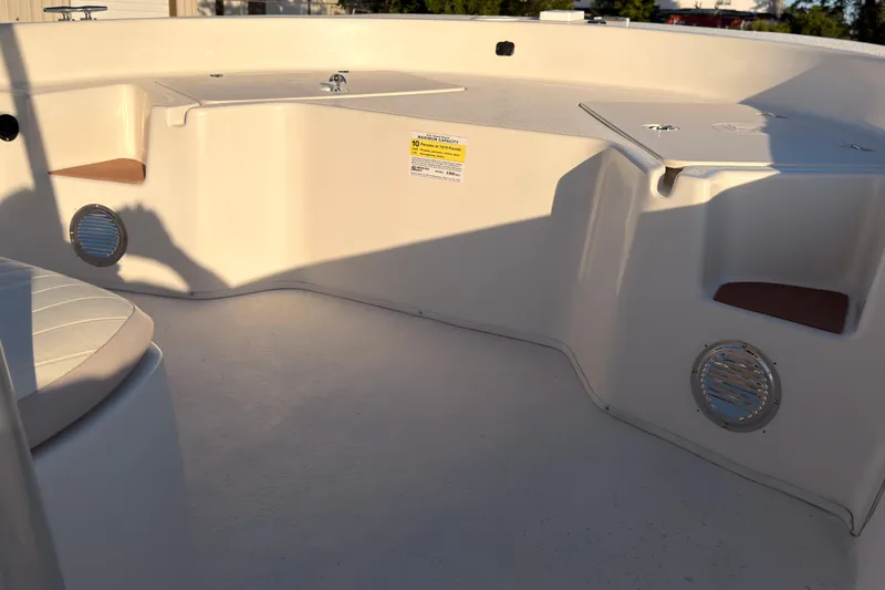 Slide: The Image of 2013 Carolina Skiff 198 DLV boat interior with seating and storage compartments. - 6