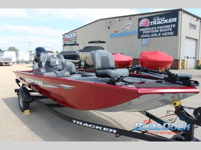 Slide: The Image of Red Pro Team 170 boat, 2026 model, parked outside a boat dealership. - 3