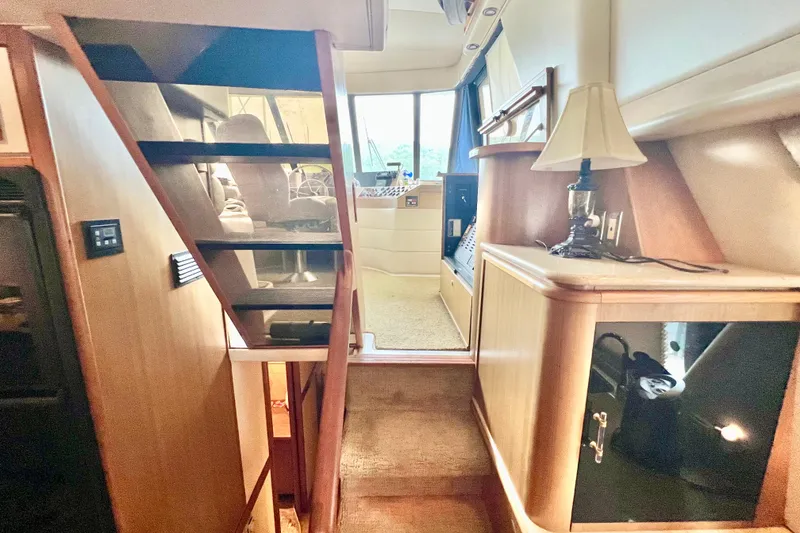 Slide: The Image of Interior of 2001 Bayliner 4788 Pilot House Motoryacht with stairs and elegant furnishings. - 10