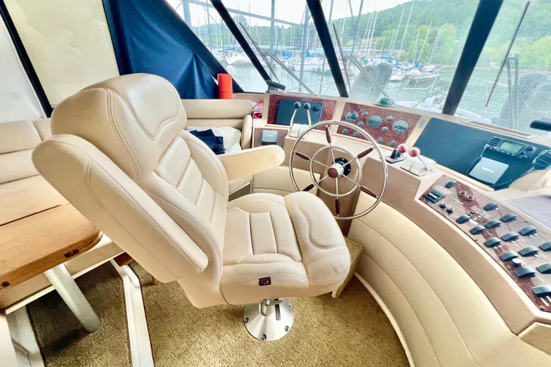 Slide: The Image of Luxurious helm of 2001 Bayliner 4788 Pilot House Motoryacht with plush seating and controls. - 13