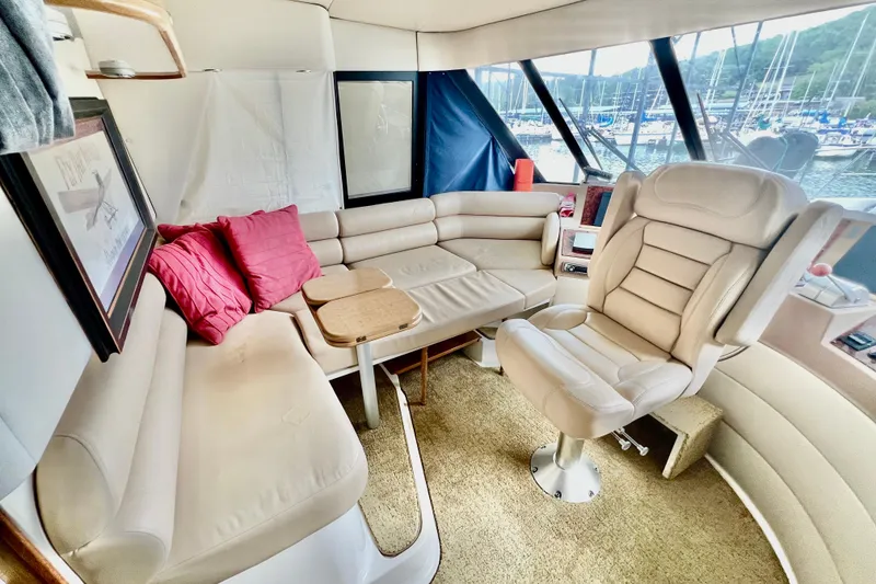 Slide: The Image of Luxurious interior of 2001 Bayliner 4788 Pilot House Motoryacht with plush seating and helm chair. - 14