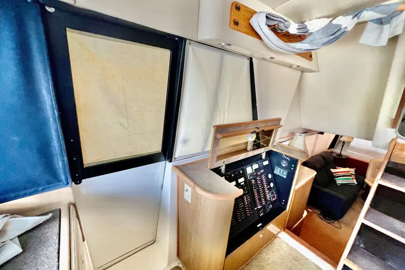 Slide: The Image of Interior of 2001 Bayliner 4788 Pilot House Motoryacht with control panel and seating area. - 15