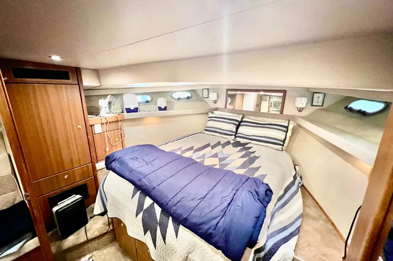 Slide: The Image of Luxurious bedroom interior of 2001 Bayliner 4788 Pilot House Motoryacht with cozy bedding. - 23