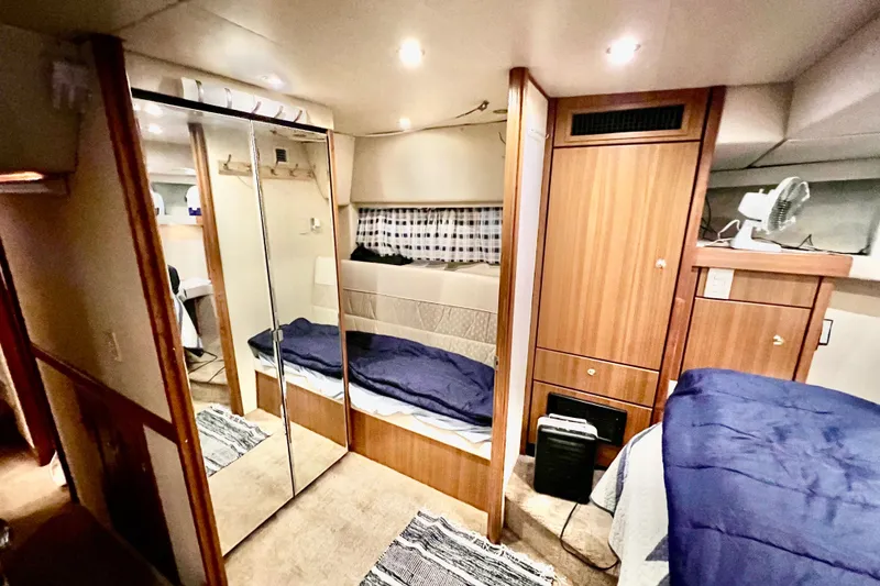 Slide: The Image of Interior of 2001 Bayliner 4788 Pilot House Motoryacht with cozy cabin and mirrored closet. - 24