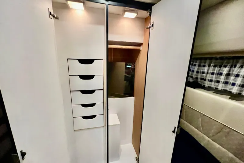 Slide: The Image of Interior of 2001 Bayliner 4788 Pilot House Motoryacht with open closet and drawers. - 25