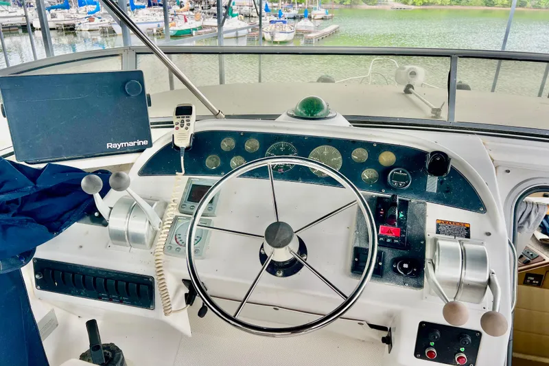 Slide: The Image of 2001 Bayliner 4788 Pilot House Motoryacht helm with steering wheel and navigation equipment. - 27