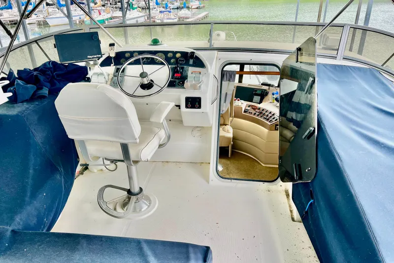 Slide: The Image of 2001 Bayliner 4788 Pilot House Motoryacht helm with steering wheel and navigation equipment. - 28