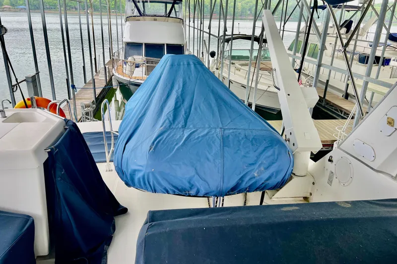 Slide: The Image of 2001 Bayliner 4788 Pilot House Motoryacht docked, covered equipment, marina background. - 29