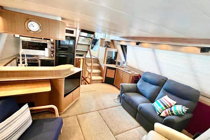 Slide: The Image of Luxurious interior of 2001 Bayliner 4788 Pilot House Motoryacht with cozy seating and modern kitchen. - 4