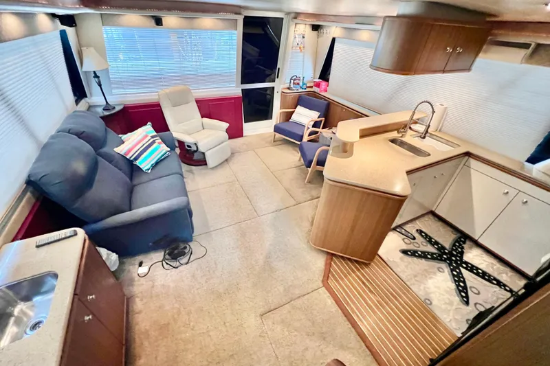 Slide: The Image of Interior of 2001 Bayliner 4788 Pilot House Motoryacht with cozy seating and modern kitchen. - 5
