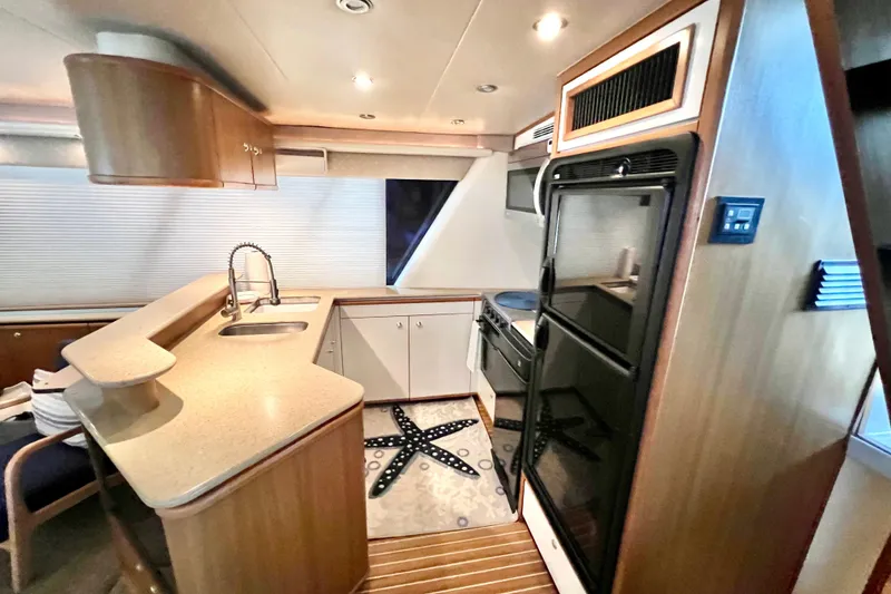 Slide: The Image of Luxurious kitchen interior of 2001 Bayliner 4788 Pilot House Motoryacht with modern amenities. - 6