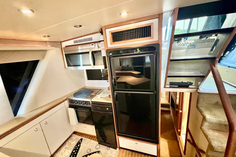 Slide: The Image of 2001 Bayliner 4788 Pilot House Motoryacht kitchen interior with modern appliances and sleek design. - 7