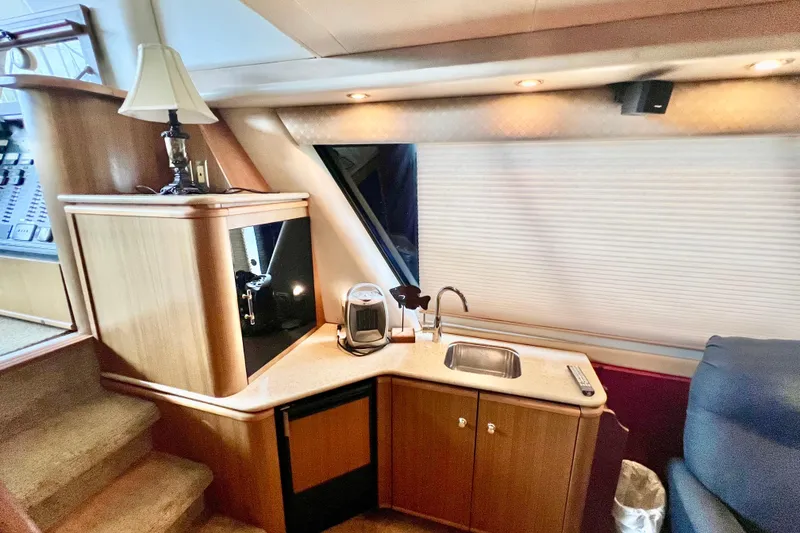 Slide: The Image of Interior of 2001 Bayliner 4788 Pilot House Motoryacht with kitchenette and seating area. - 8