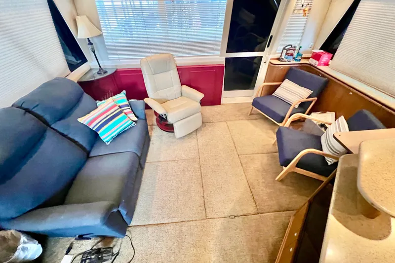 Slide: The Image of Interior of 2001 Bayliner 4788 Pilot House Motoryacht with cozy seating and colorful pillows. - 9