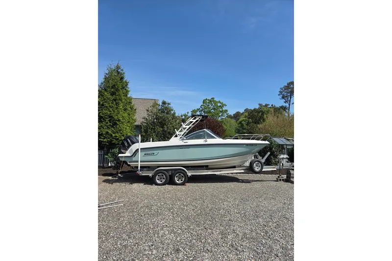 The Image of 2018 Boston Whaler 230 Vantage boat on trailer, parked outdoors. - 0