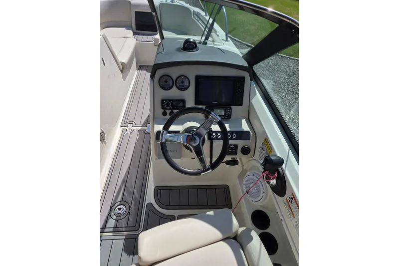 Slide: The Image of 2018 Boston Whaler 230 Vantage boat cockpit with steering wheel and control panel. - 12