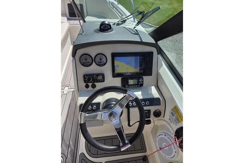 Slide: The Image of 2018 Boston Whaler 230 Vantage helm with steering wheel, gauges, and navigation system. - 20