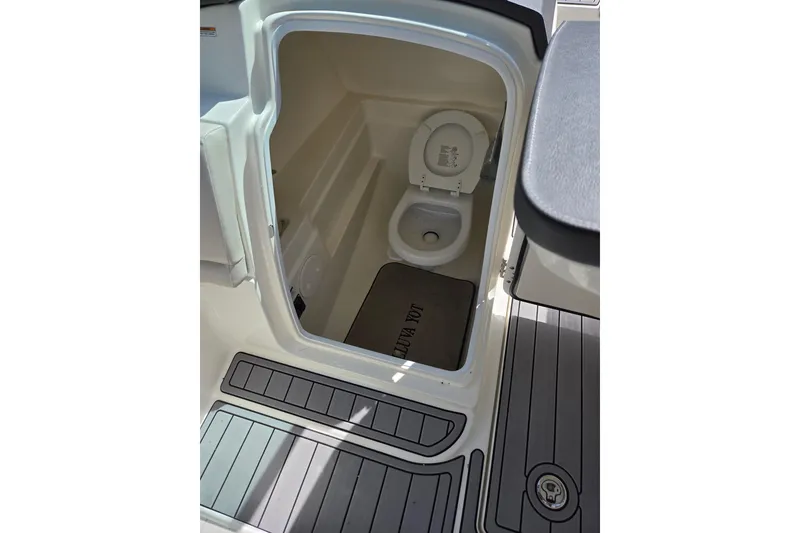 Slide: The Image of Interior view of 2018 Boston Whaler 230 Vantage boat's compact marine toilet. - 22