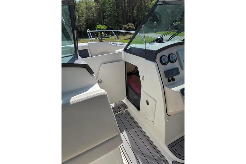 Slide: The Image of 2018 Boston Whaler 230 Vantage boat interior with dashboard and seating area. - 24
