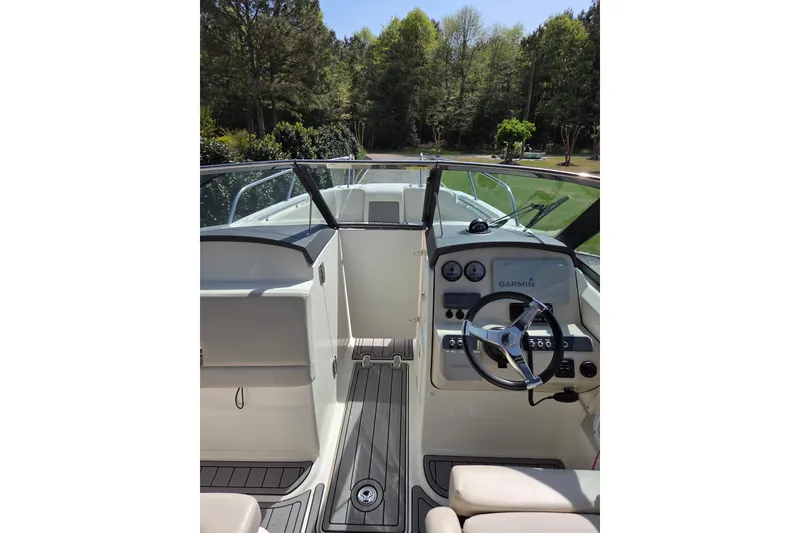 Slide: The Image of 2018 Boston Whaler 230 Vantage boat interior with steering wheel and Garmin navigation system. - 26
