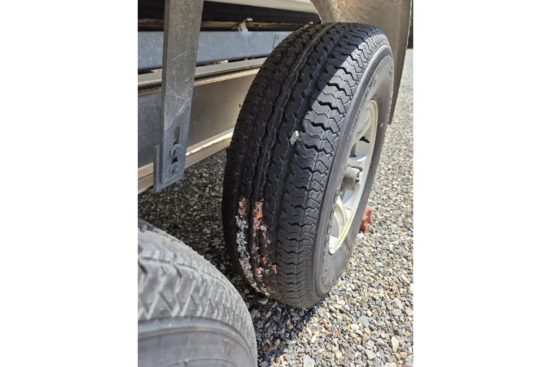 Slide: The Image of Damaged tire on a trailer for a 2018 Boston Whaler 230 Vantage boat. - 29