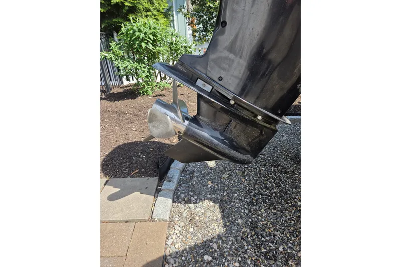 Slide: The Image of Close-up of a 2018 Boston Whaler 230 Vantage boat motor on gravel. - 30