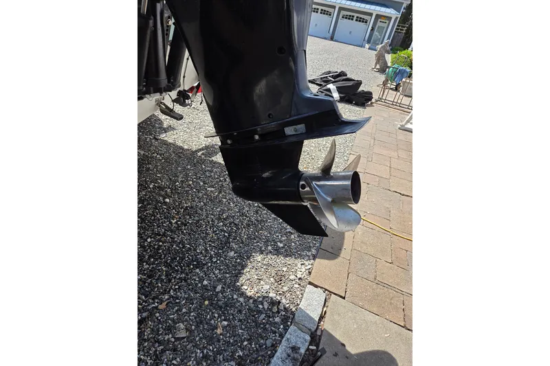 Slide: The Image of 2018 Boston Whaler 230 Vantage boat propeller on gravel driveway. - 31