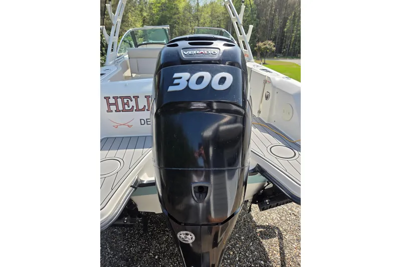 Slide: The Image of 2018 Boston Whaler 230 Vantage with powerful 300 Verado outboard engine, docked outdoors. - 32