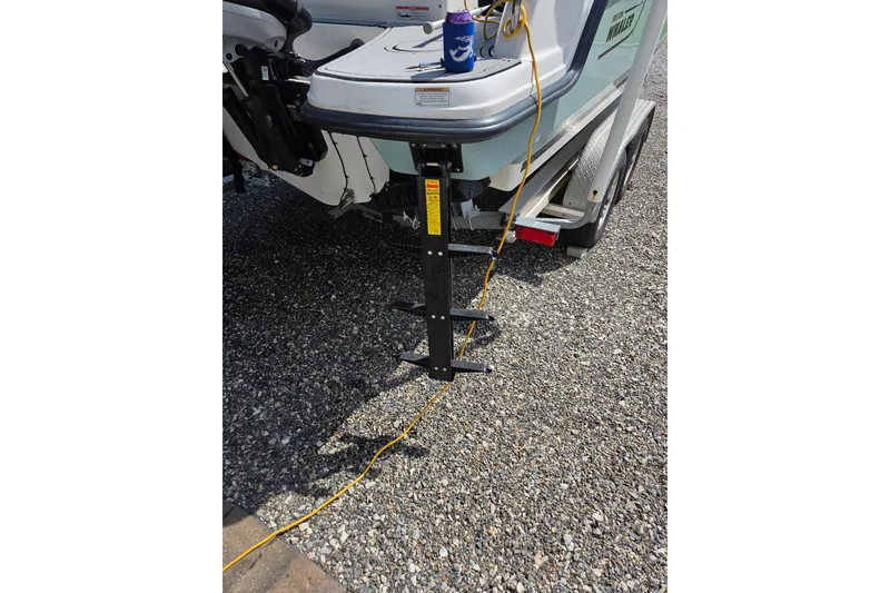 Slide: The Image of 2018 Boston Whaler 230 Vantage boat on trailer with ladder and power cable. - 34