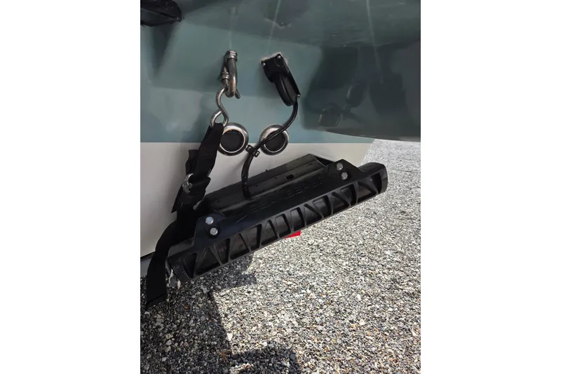 Slide: The Image of 2018 Boston Whaler 230 Vantage boat trailer hitch detail on gravel surface. - 35