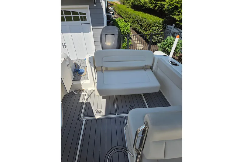 Slide: The Image of 2018 Boston Whaler 230 Vantage boat interior with seating and deck view. - 4