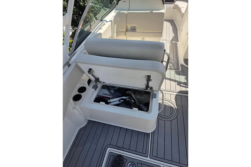 Slide: The Image of 2018 Boston Whaler 230 Vantage boat interior with open storage compartment and seating. - 6