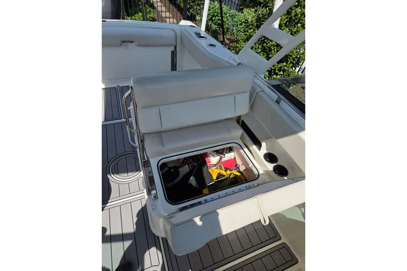 Slide: The Image of 2018 Boston Whaler 230 Vantage boat interior with open storage compartment and seating. - 7