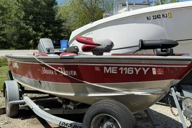 Slide: The Image of 1993 Lund 1700 Pro Angler boat on trailer, red and silver, labeled "Haven's Haven." - 2