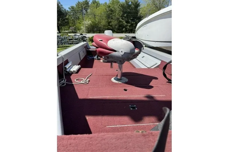 Slide: The Image of 1993 Lund 1700 Pro Angler boat interior with red seating and carpet. - 3