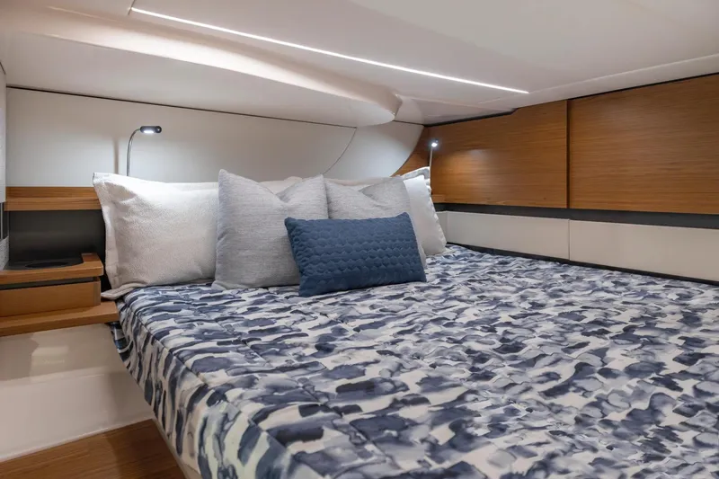 Slide: The Image of Manufacturer Provided Image: Luxurious cabin interior of 2026 Tiara Yachts 46 LS with modern bedding and lighting. - 18